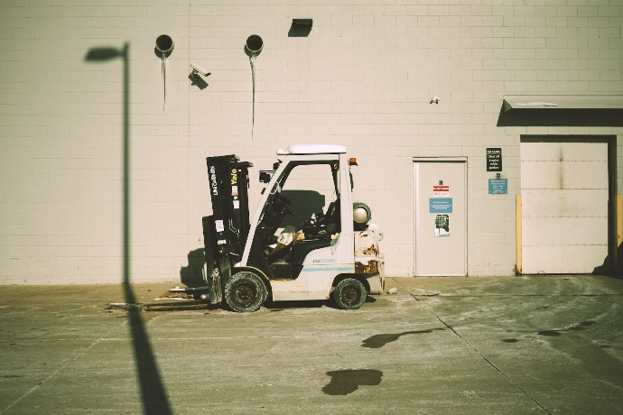a forklift parked in front of a building